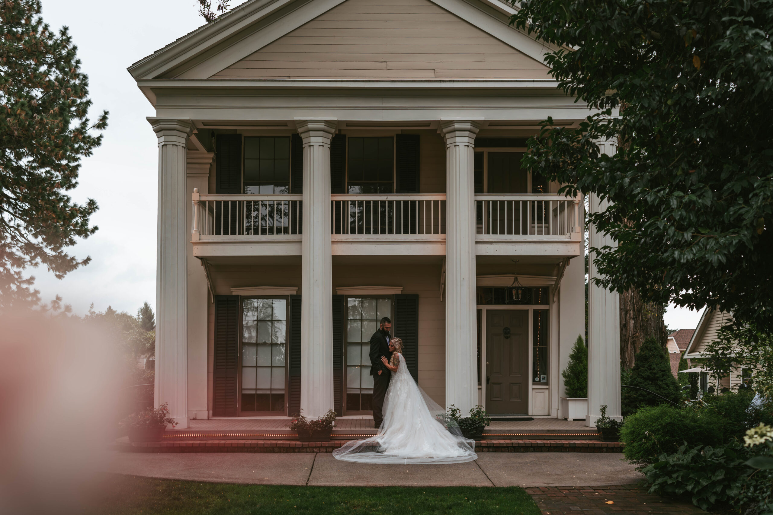 wedding at the Ainsworth House and gardens venue couple standing in front of house