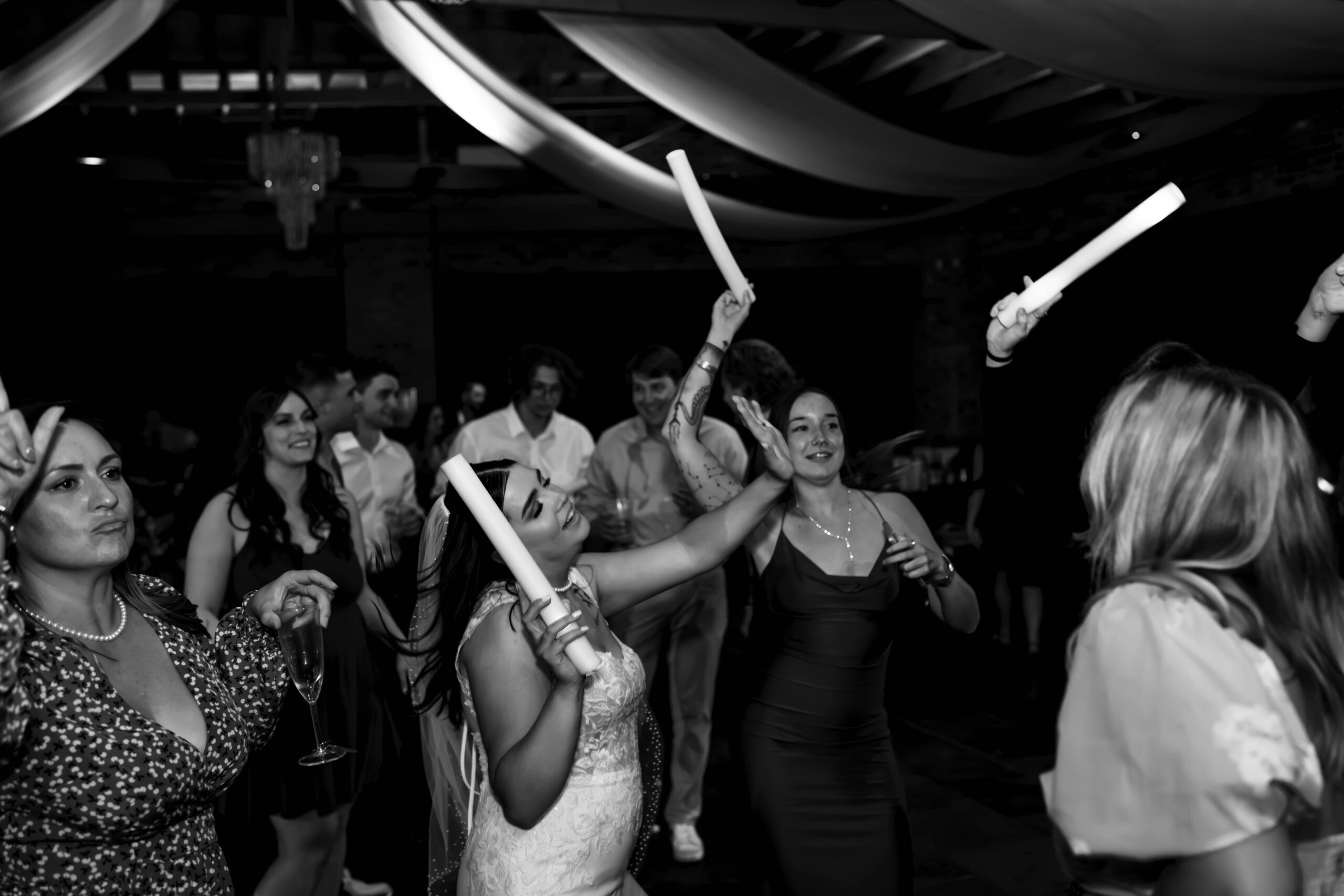 black and white of wedding reception with people dancing around indoors at Historic 1625 Tacoma in Washington