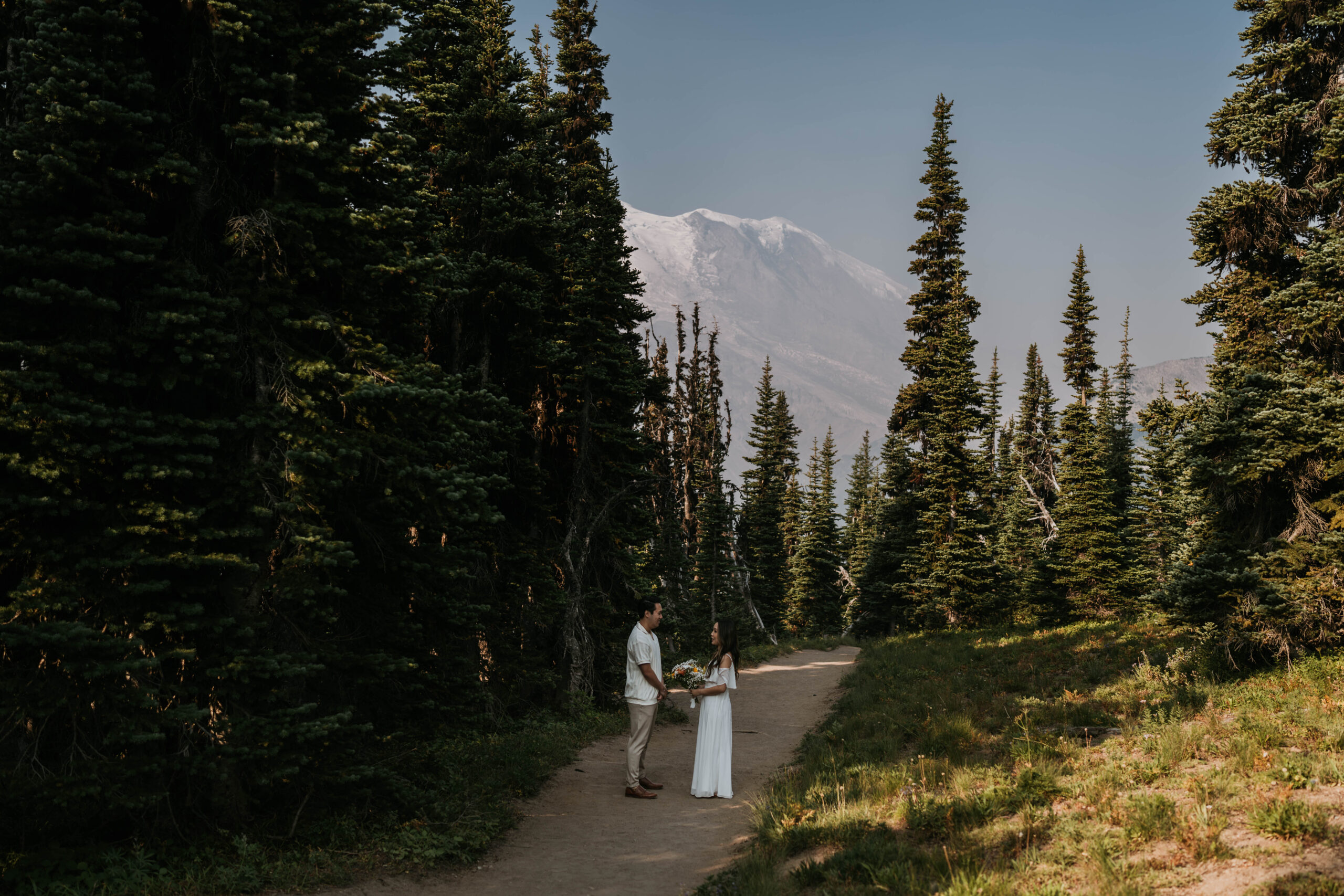 bride and groom exchanging vows in mount Rainer with mountain as backdrop